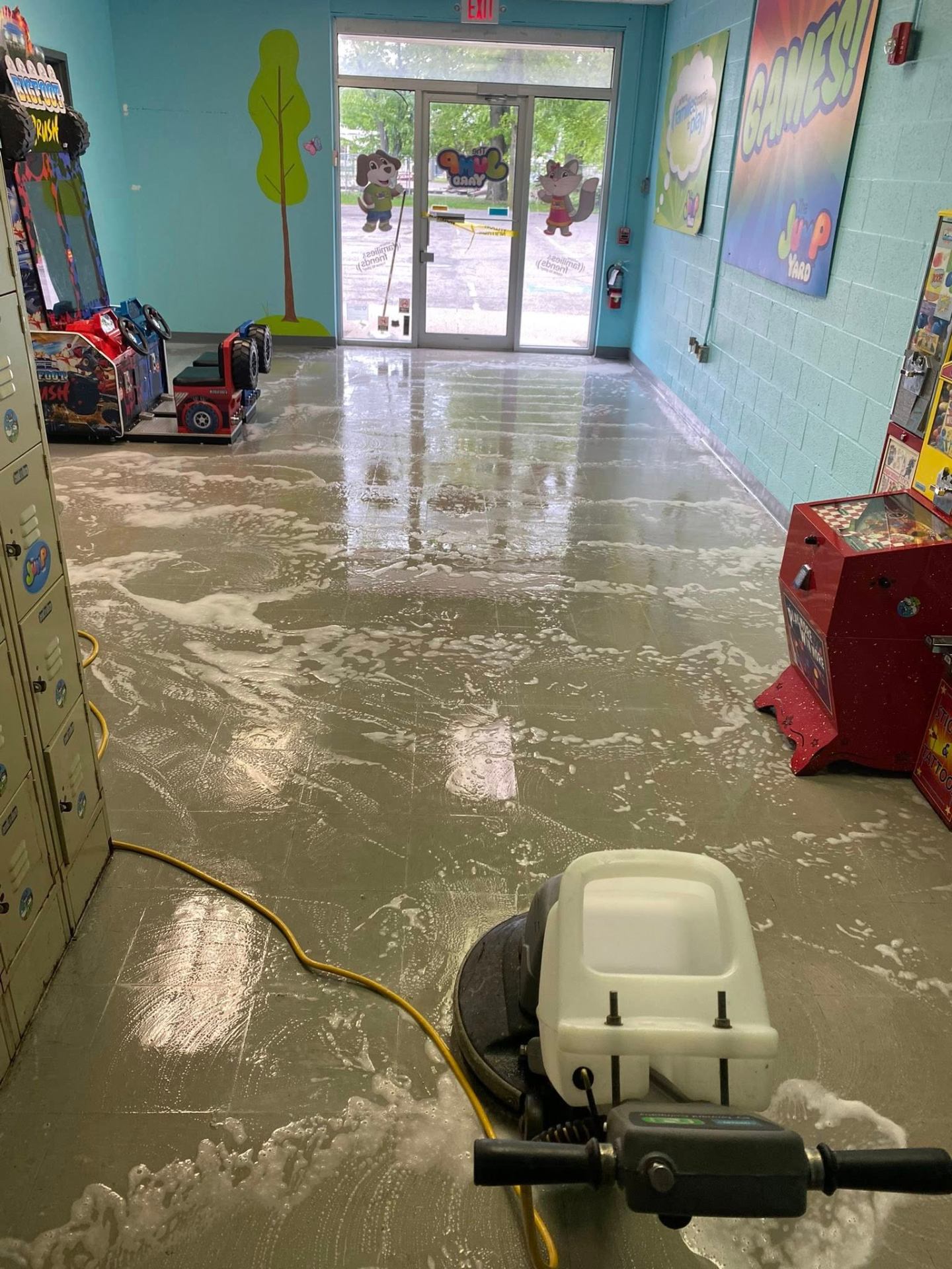 Scrubbing a tile floor at a local family entertainment center